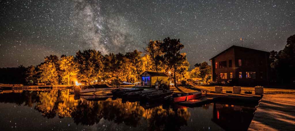 Resort docks and cabins at night under stars.